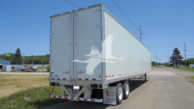 Trailer rear and side view of a Vanguard VXP trailer with dual rear wheels and white exterior.
