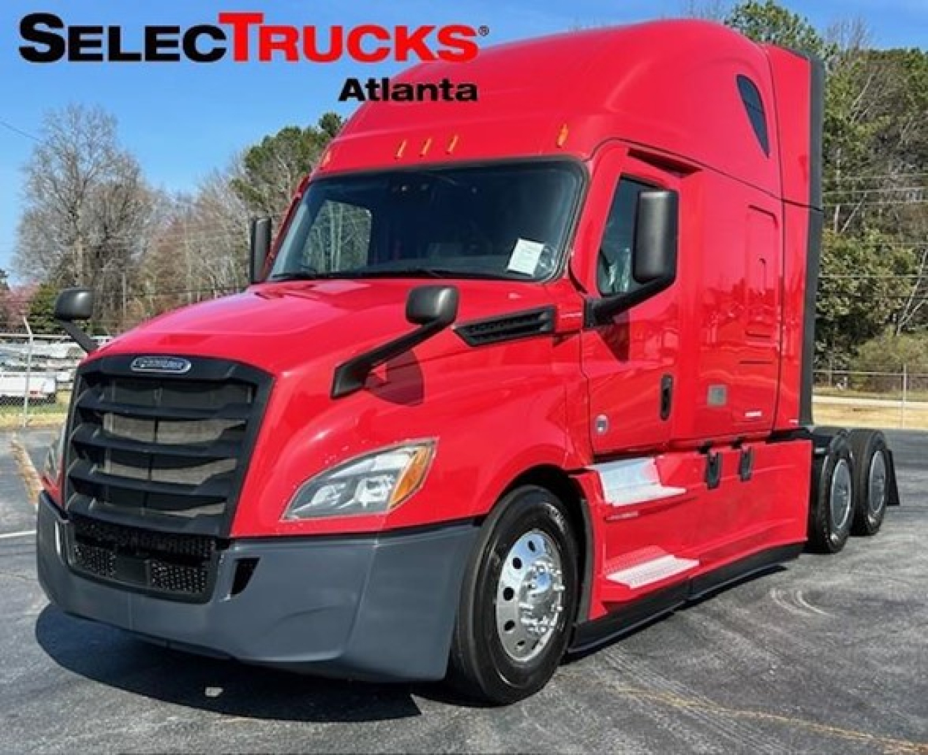Freightliner Cascadia 126 sleeper cab truck in red profile view showing stock photo at dealer lot.