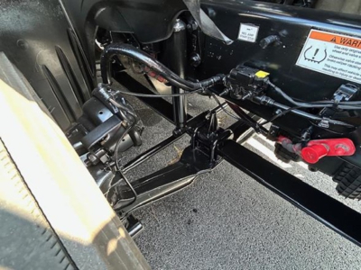 Truck chassis showing electrical harness and frame near cab mounting on a 2022 Freightliner Cascadia 126.