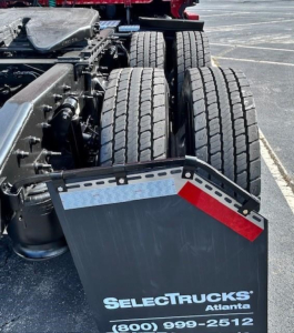 Freightliner Cascadia 126 rear view showing dual rear axles and trailer mudguard with SelectTrucks Atlanta text.