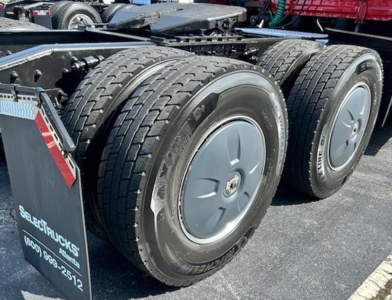 Freightliner Cascadia 126 rear wheels and frame showing dual rear axles and wheel rims.