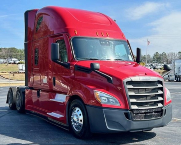 Freightliner Cascadia 126 sleeper cab truck in red, front three-quarter view.