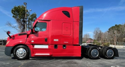 Freightliner Cascadia 126 sleeper cab side view with red exterior and dual rear axles.