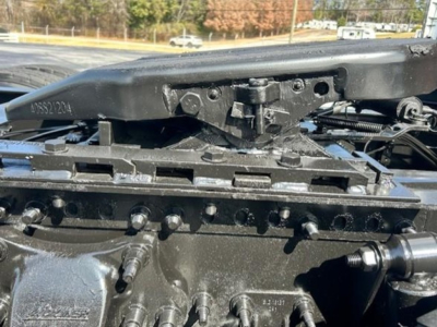 Truck cab front with fifth wheel hinge and air hoses in view