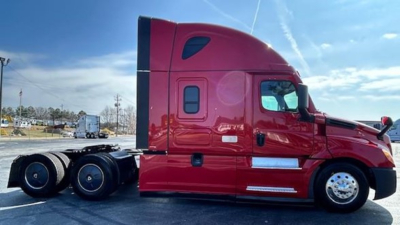 Truck cab side view showing Freightliner Cascadia 126 tractor with red paint and sleeper cab, two rear dual axles, chrome wheels, and side mirrors.