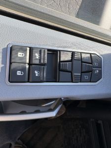 Truck interior door panel with window/lock controls; four window buttons, lock switch icons visible