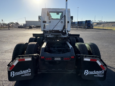 Tractor truck rear view showing dual rear axles and mud flaps with Bruckner's Truck & Equipment branding.