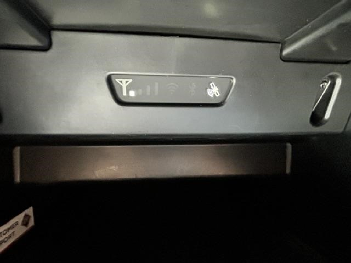 Interior switch panel showing a power/seat heater or generic control with icons, and a slot below; part of a cab interior in a used 2021 International LT truck.