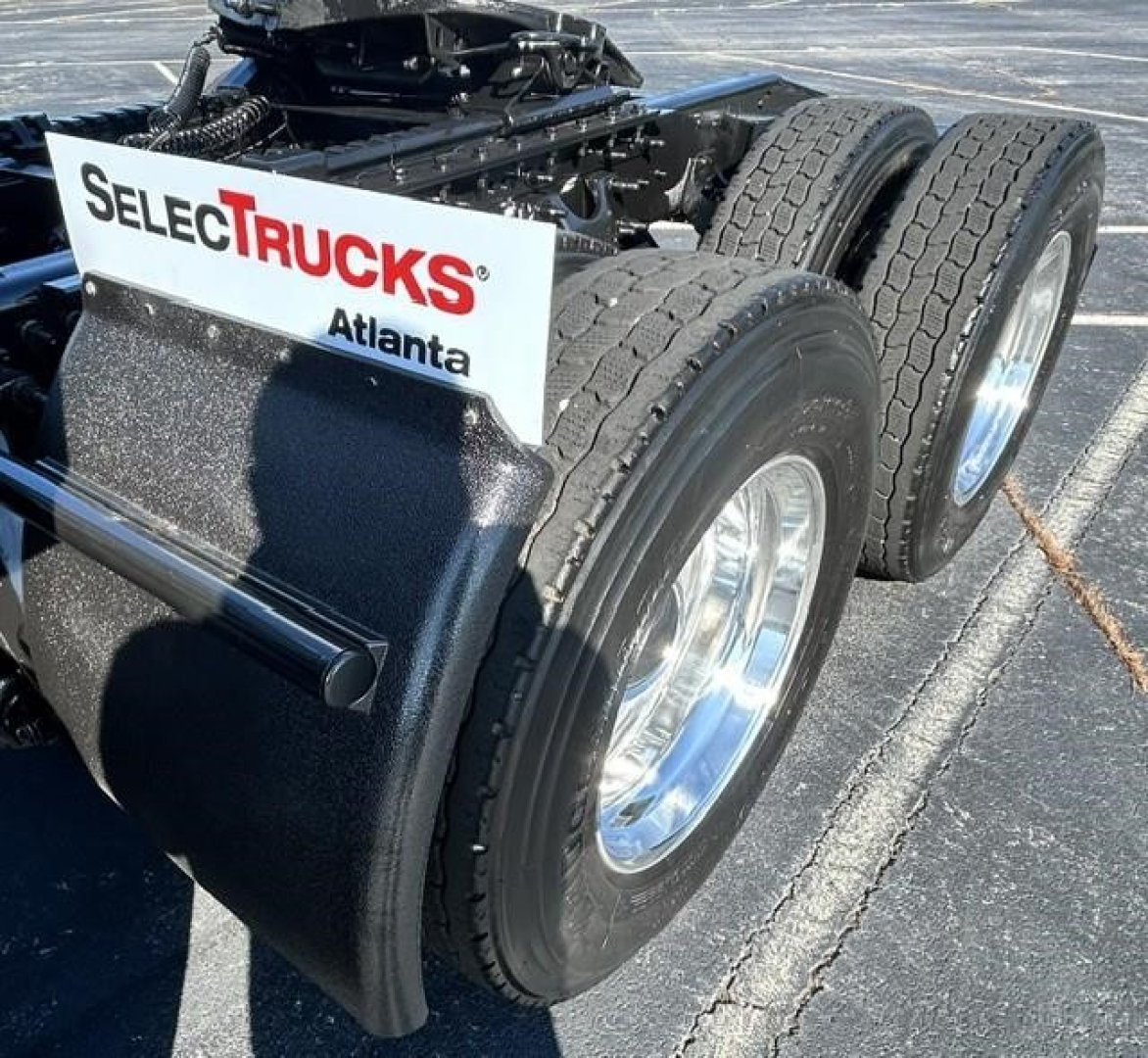 Dual rear axles with tires and chrome rims; sign on mudflap reads SELECTTRUCKS Atlanta.