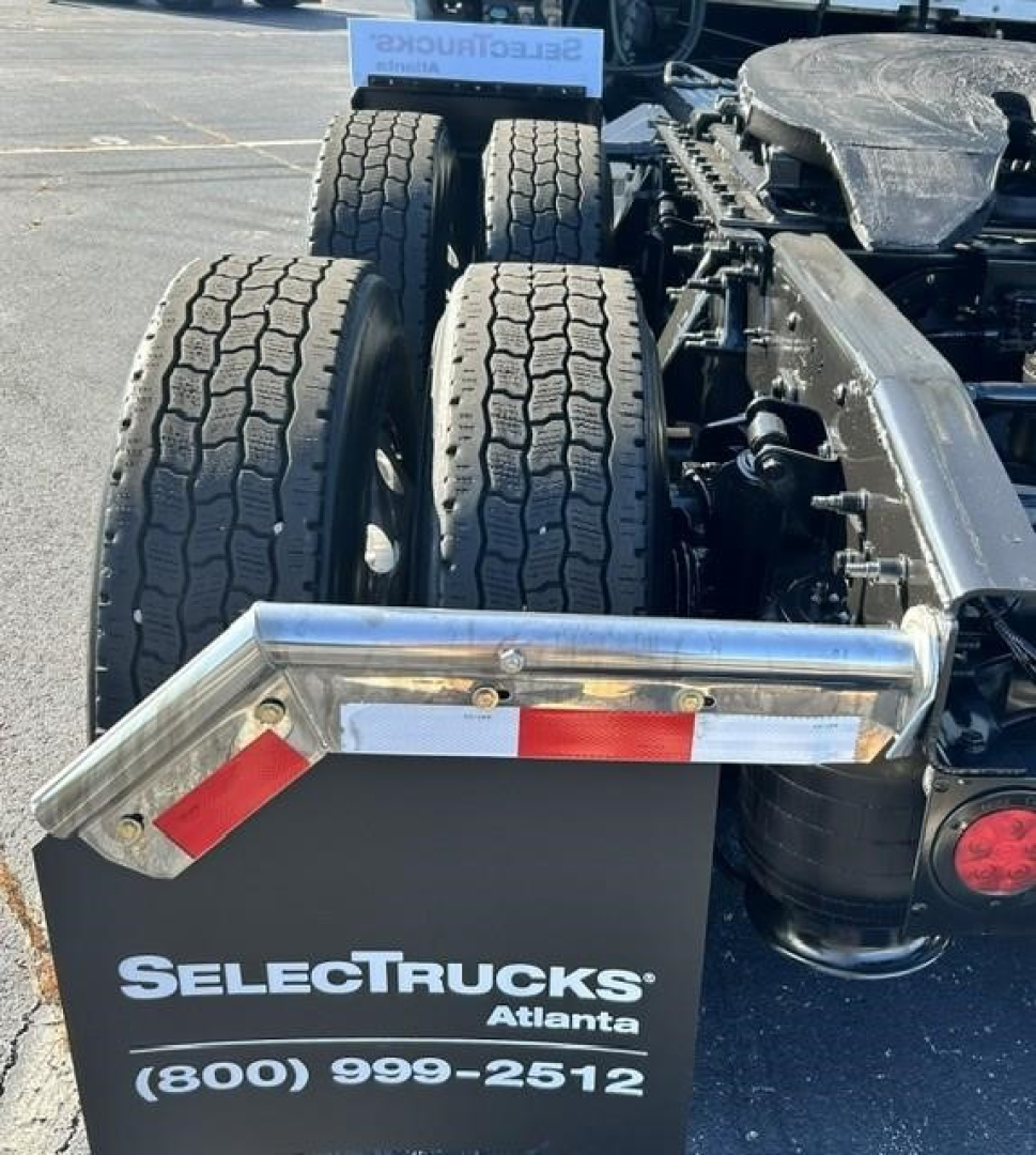 Truck rear view showing dual rear axles and fender with SelectTrucks Atlanta plate and contact number.