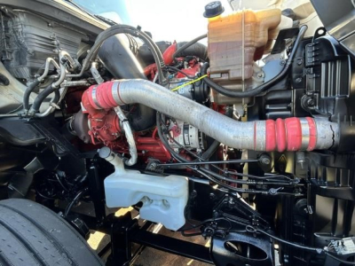 International LT engine bay showing radiator reservoir, red turbocharger piping, coolant reservoir, and various hoses.