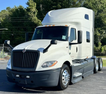 International LT truck in white cab-over-engine with sleeper, stock image showing front-left view