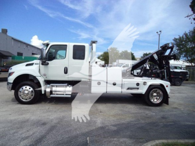 International MV tow truck side view showing winch equipment and towing bed with hydraulic arm