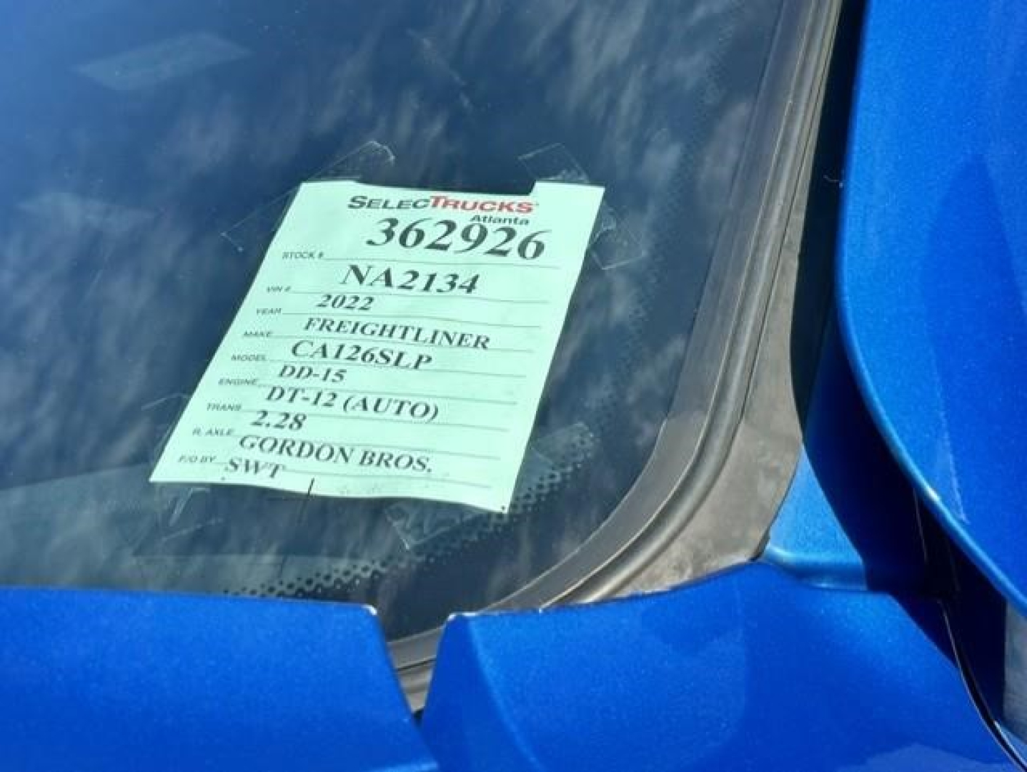 Truck window tag showing stock 362926, NA2134, 2022 Freightliner Cascadia 126 with model C; DD-15; DT-12 (AUTO); 2.28 miles? not readable.