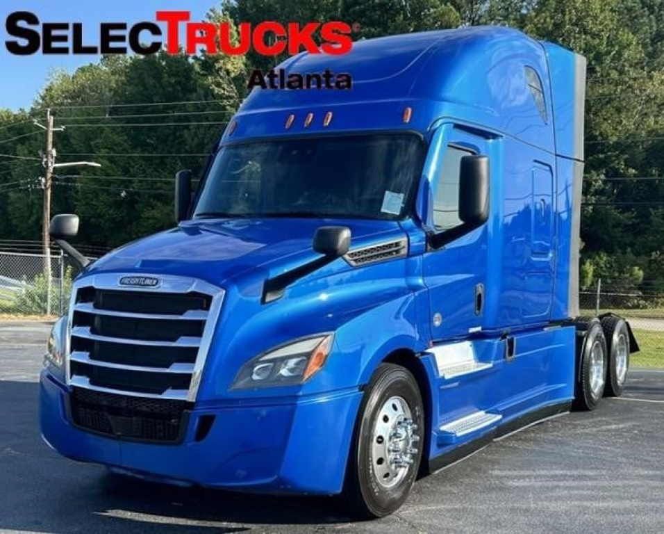 Blue Freightliner Cascadia 126 sleeper cab truck showing front and side view with SelectTrucks Atlanta logo.
