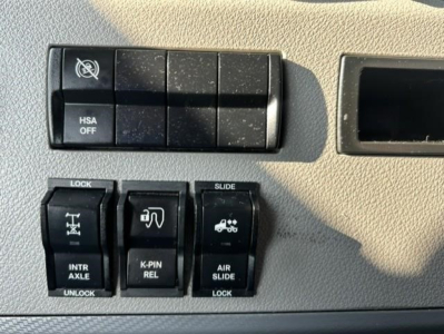 Cab interior switch panel with HSA OFF and various controls, including lock, slide, and air slide switches in a Freightliner Cascadia truck.