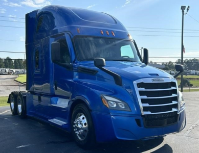 Freightliner Cascadia 126 semi-truck in blue, front-right view with sleeper cab and chrome grille.