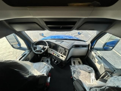 Cab of a 2022 Freightliner Cascadia 126 truck showing steering wheel dashboard and seating area.