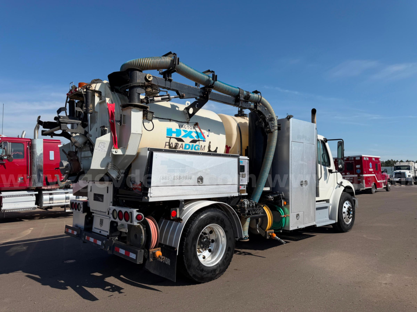 Freightliner Vactor vacuum truck rear three-quarter view showing large suction hose and tank with LXI Florida Dig...