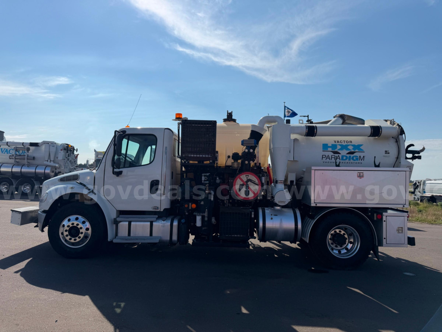 Freightliner Vactor vacuum truck side view showing Waste water tank and dual rear wheels with labeling and equipment hoses.