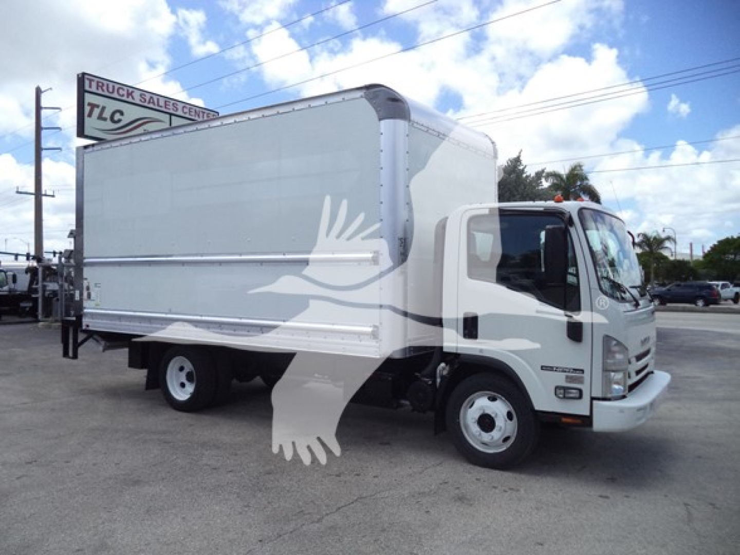 Box truck 2021 Isuzu NPR in service bay with white cab and large cargo box, VIN 54DC4W1D9MS201732, stock T01732, category Box, used.