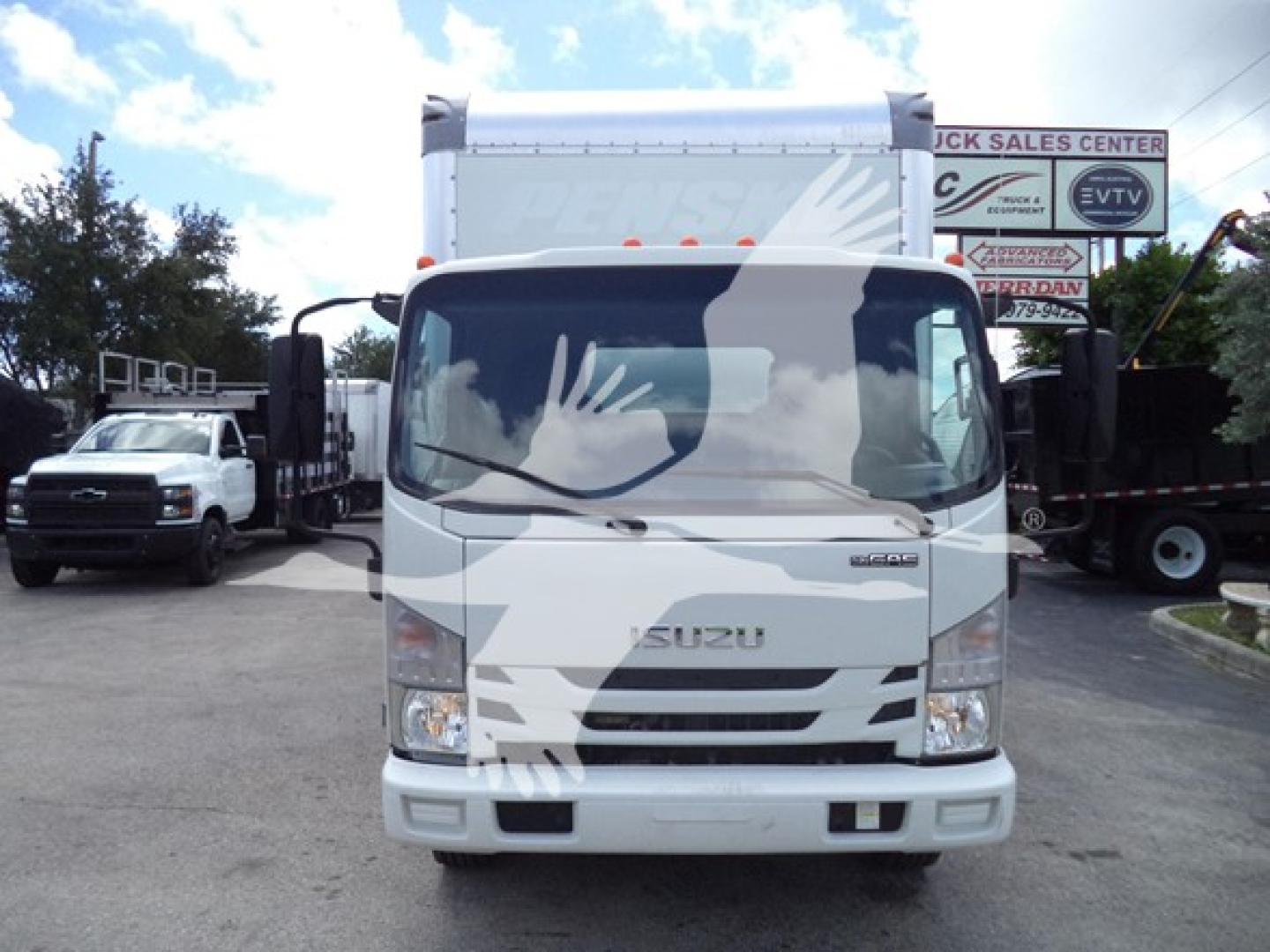 Isuzu NPR box truck front view showing cab and windshield with Isuzu emblem