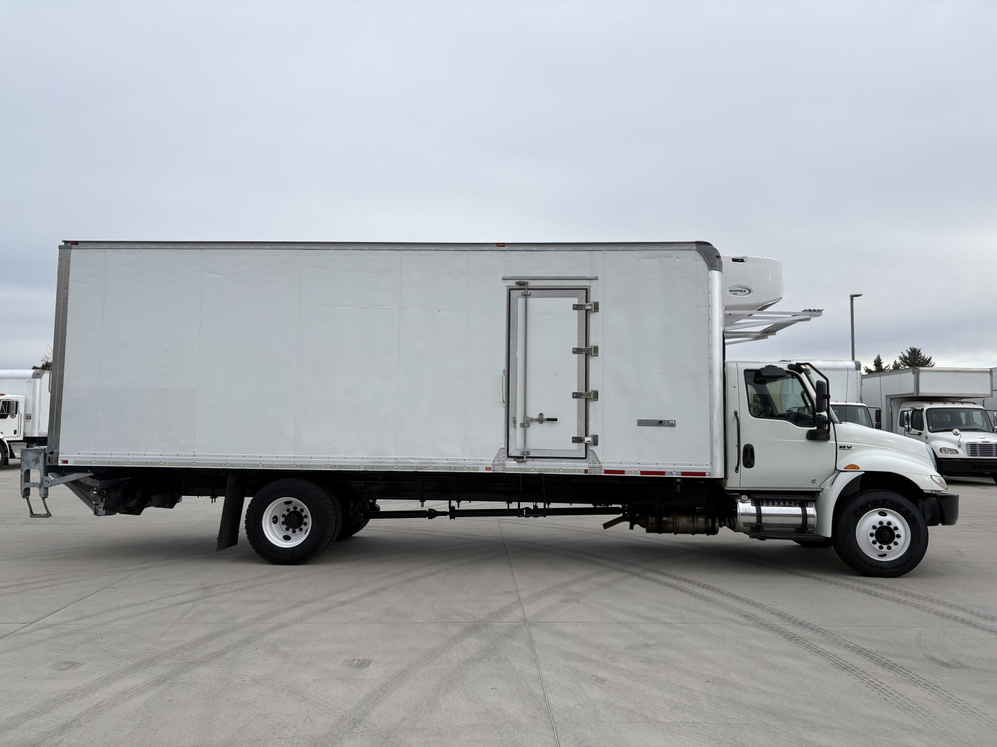 Truck cab and refrigerated box on International MV607 with side load door and refrigeration unit.