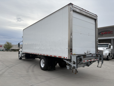 2020 International MV607 refrigerated truck with a box trailer, rear roll-up door, and metal framing. Vehicle appears in a dealership lot.