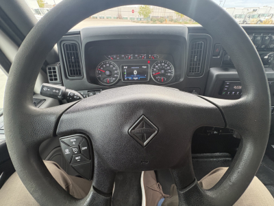 Truck interior dashboard with steering wheel centered, instrument cluster and dashboard vents visible.