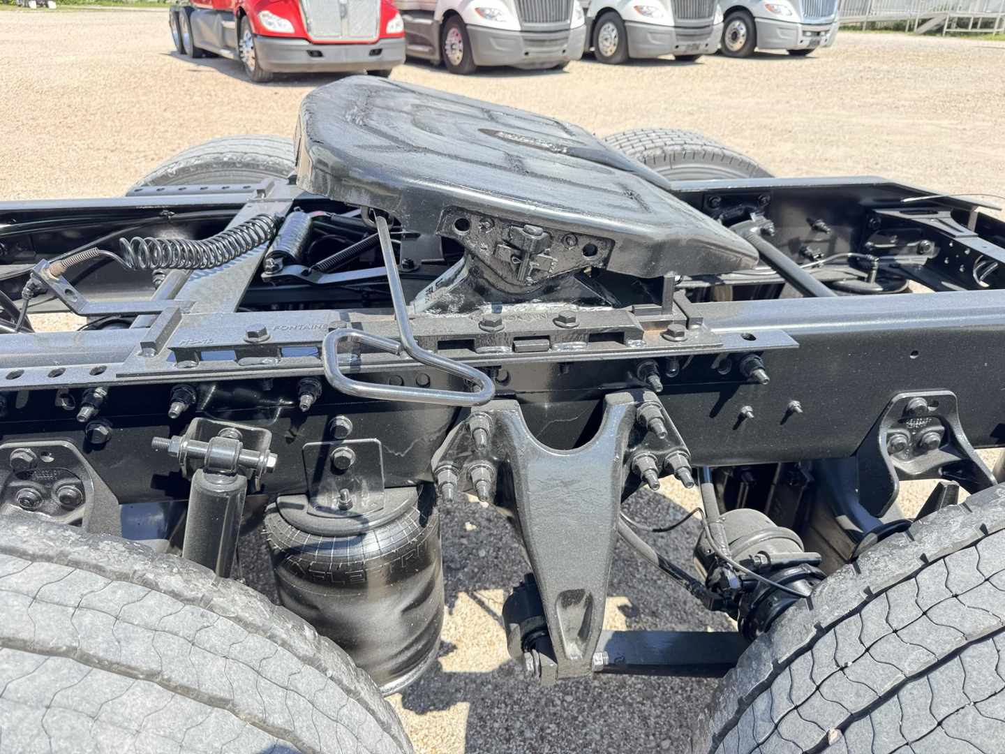 Rear view of a 2020 International LT truck chassis showing the fifth wheel area, air suspension, and dual rear axle with visible wiring and components.
