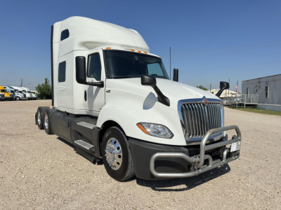 Truck cab of a white 2020 International LT sleeper tractor shown from front-left angle with grille guard and dual headlights.