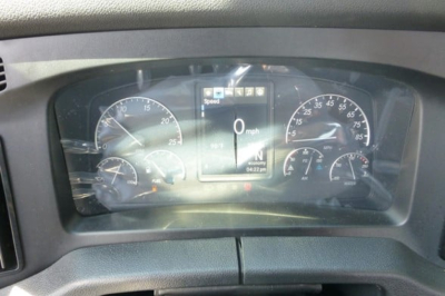 Dashboard view of a Freightliner Cascadia instrument cluster displaying speedometer, tachometer, and digital gauge readouts.