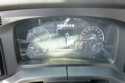 Dashboard cluster of a Freightliner Cascadia showing speedometer, tachometer, and digital display with 0 mph. Various gauges and warning icons visible.