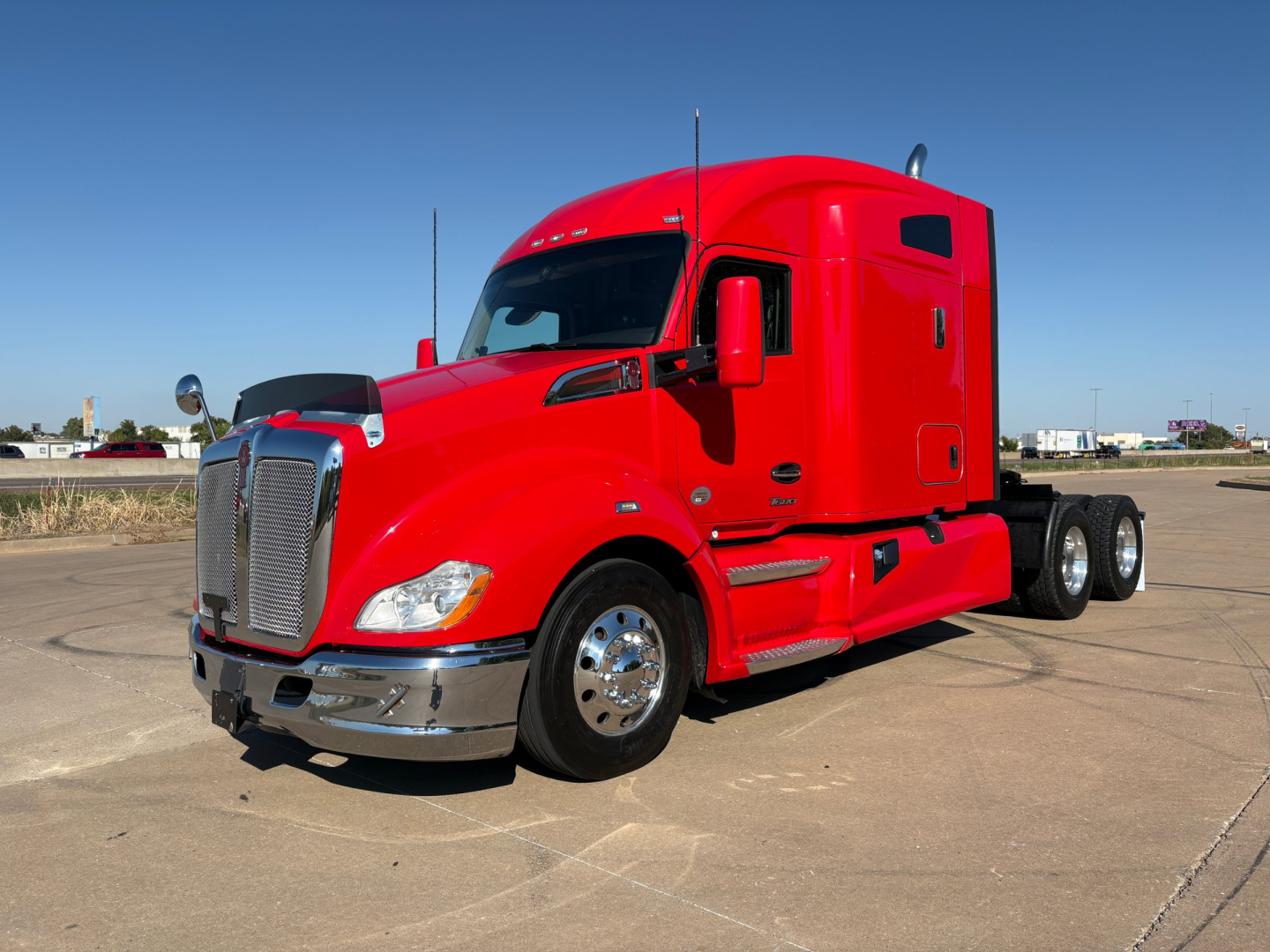 Kenworth T680 conventional sleeper truck in red, front-left view; chrome grille, large bumper, dual rear axles; no visible text on labels.