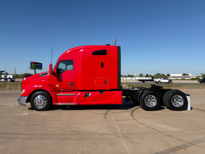 Red Kenworth T680 tractor side view showing sleeper cab, dual rear axles, chrome wheels, and streamlined body.