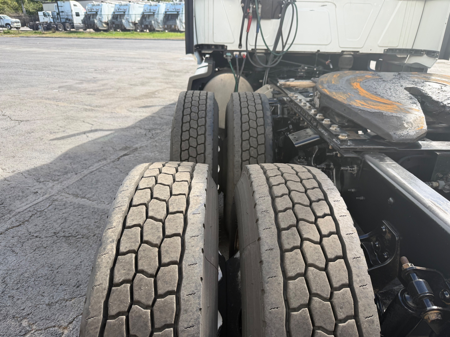 Dual rear axle of a 2021 International LT625 truck showing multiple tires and fifth-wheel area.