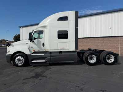 International LT625 tractor unit side view showing cab with sleeper, fuel tanks, and dual rear axles; no legible labels visible.