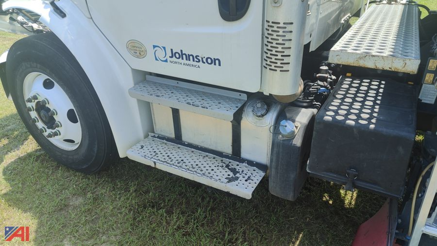 Freightliner M2 106 sweeper/vac truck side view showing steps, door, Johnson North America logo, and crew cab area.