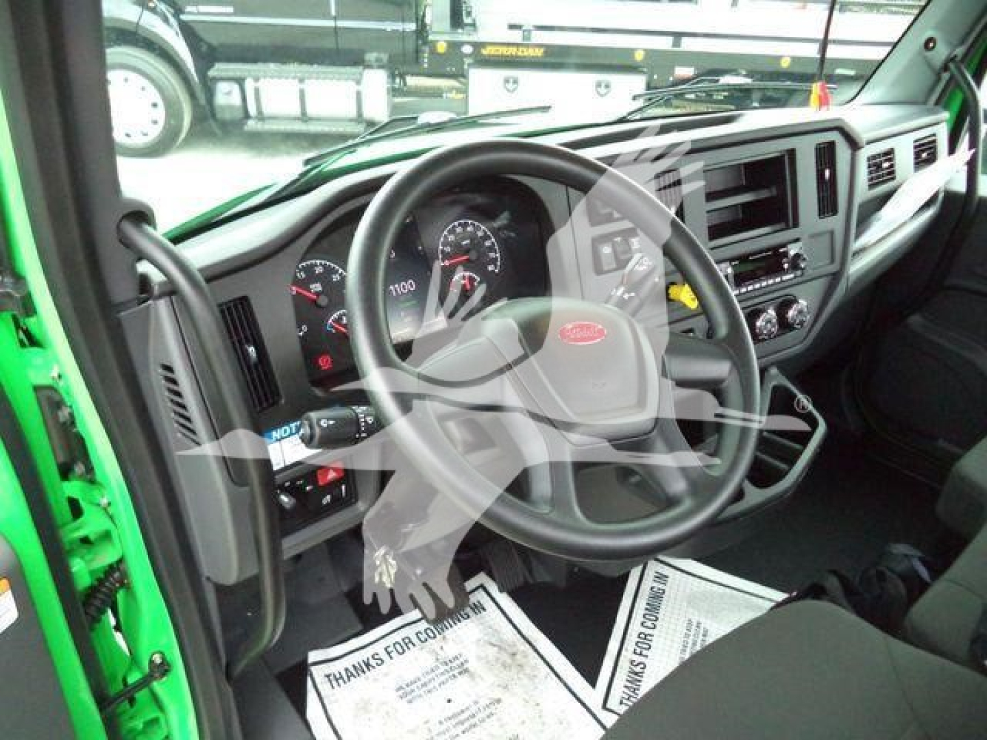 Peterbilt 536 truck cab interior showing steering wheel and dashboard with gauges and controls.