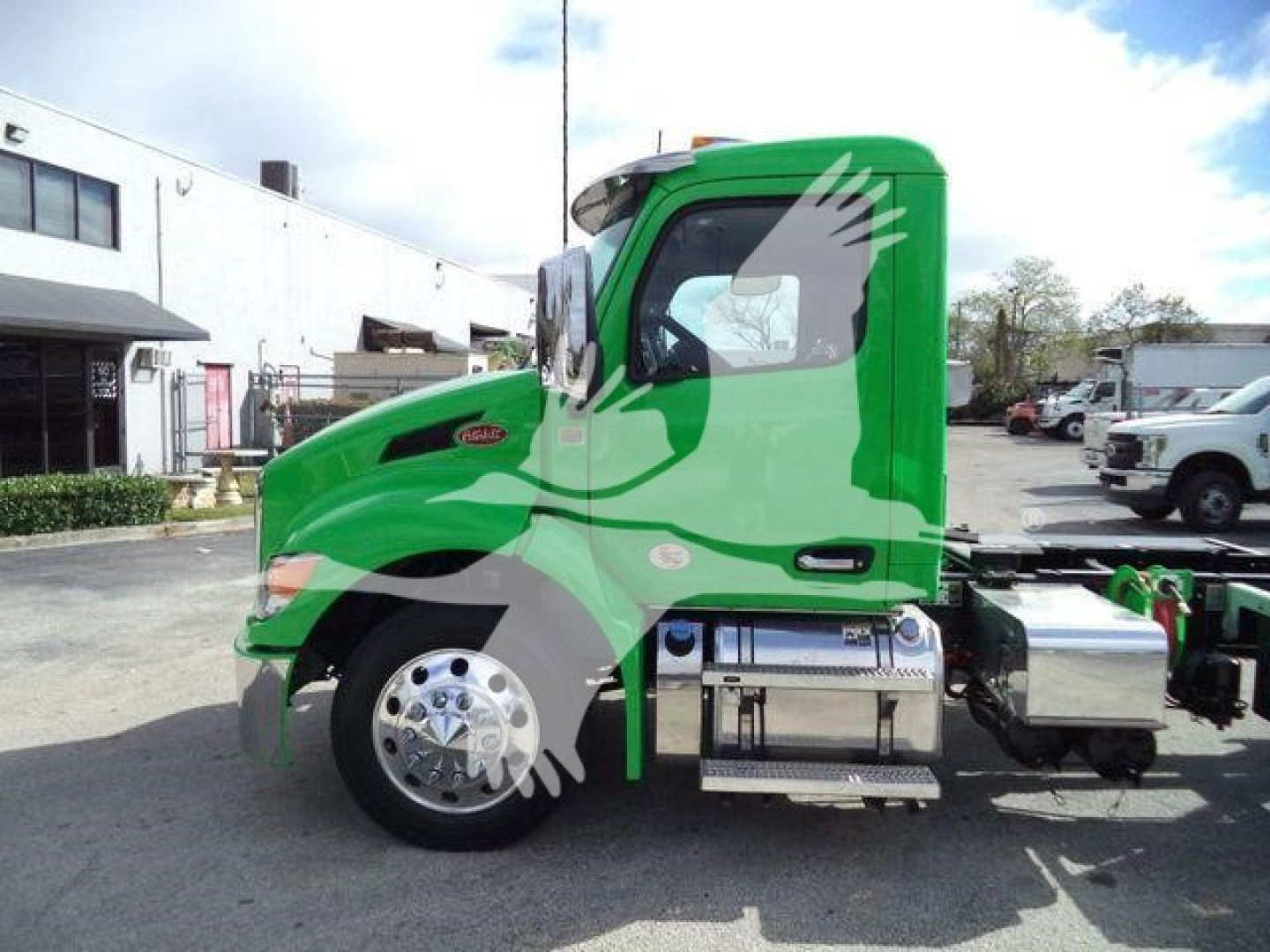 Peterbilt 536 rollback truck in bright green profile view showing cab and fuel tanks, chrome wheels, and side steps.