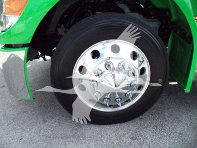 Peterbilt 536 rollback truck front wheel and green fender showing chrome hubcap and tire.