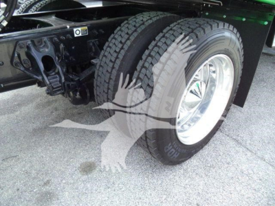 Peterbilt 536 rollback truck rear wheel and chassis view showing dual rear tires and wheel hub.