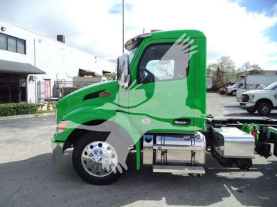 Peterbilt 536 rollback truck in bright green profile view showing cab and fuel tanks, chrome wheels, and side steps.