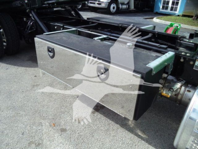 Peterbilt 536 rollback truck chassis with a rectangular metal tool/storage box mounted on the frame.
