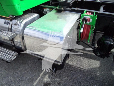 Peterbilt 536 rollback truck side view showing chrome fuel tank and green reel hose, with metal steps and access panels.