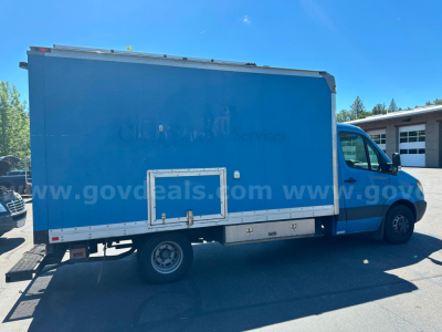 Freightliner Sprinter box truck side view showing cargo box with service access doors and aluminum storage compartments.