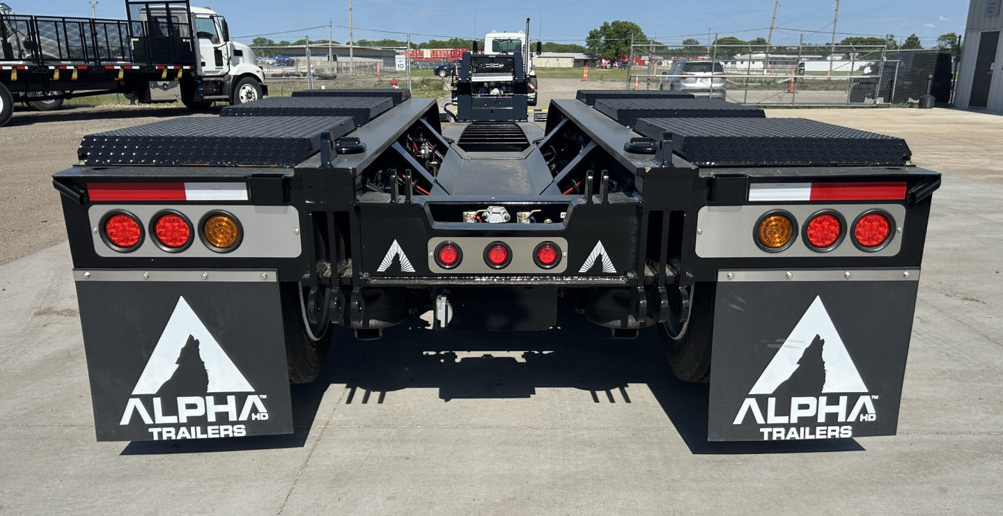 Alpha Trailers A110HDG 18 LDH lowboy trailer rear view showing taillights, mud flaps with Alpha Trailers logo, and mid-section hitch area.