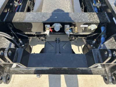 Rear view of alpha lowboy trailer hitch area showing coupler mechanisms and hydraulic lines with labels.