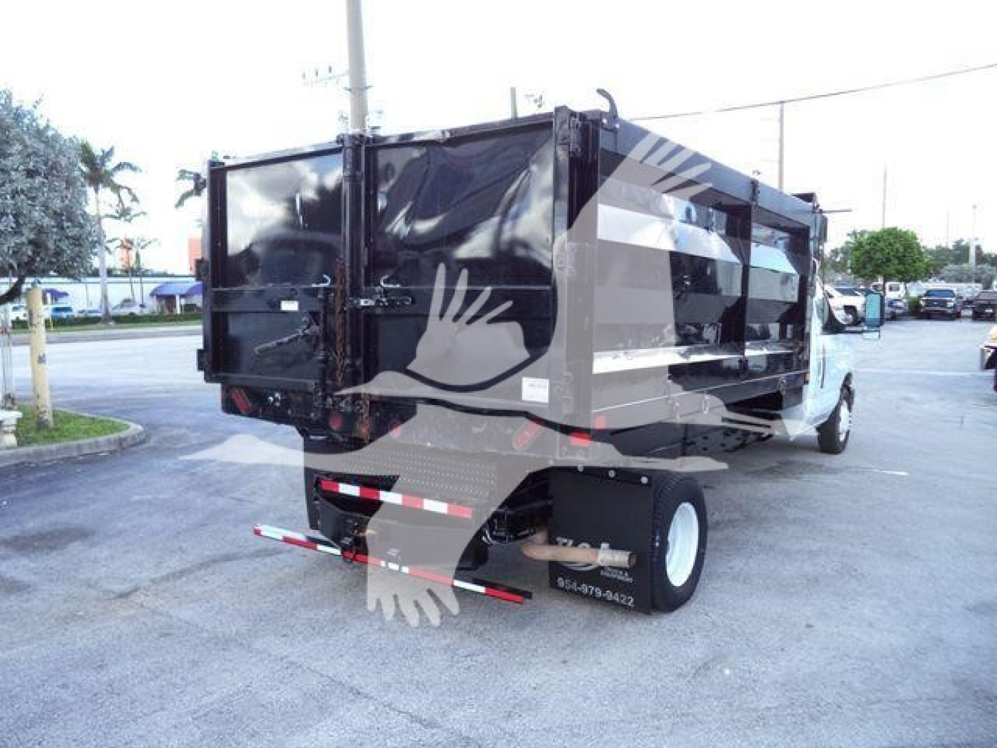 Dump truck rear view showing cargo bed and rear bumper with dual rear wheels.
