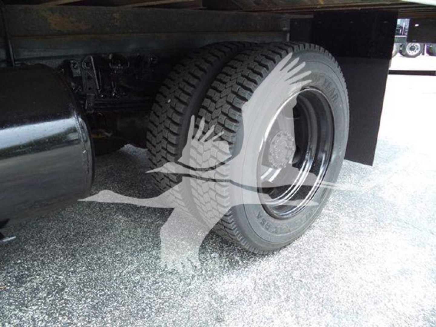 Wheel and tire close-up of a refrigerated 2020 Hino 195 truck showing rear dual wheels and undercarriage components.